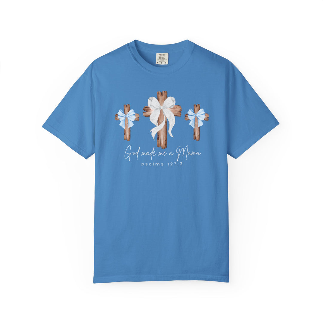 Sky-blue T-shirt with three rustic wooden crosses and white bow accents, featuring the text God made me a Mama and Psalms 127:3.