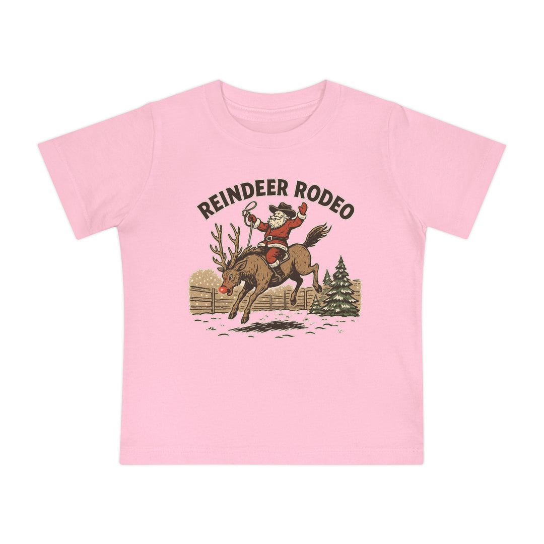 Reindeer Rodeo Baby Tee features Santa as a rodeo rider on a reindeer, with REINDEER RODEO text, ideal for stylish first steps in soft, durable cotton.