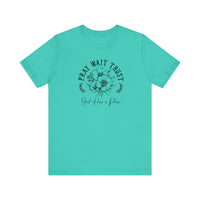 Pray Wait Trust Tee featuring a black graphic and floral design on a blue background, crafted from soft cotton with ribbed knit collars and taped shoulders.