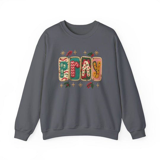 Charcoal-gray crewneck sweatshirt featuring PRAY in knitted-style letters with festive holly and star accents, combining comfort and style from Faith Family Designs.