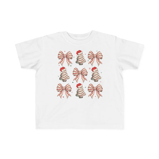 Cookies and Bows Toddler Tee features a grid of festive bows and Christmas trees with Santa hats, printed on a soft, durable cotton shirt for toddlers.