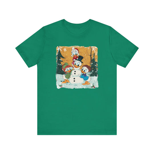 Duck Snowmen Tee features Donald Duck and nephews building a snowman in a snowy forest, capturing festive charm on a classic, soft cotton crew-neck T-shirt.