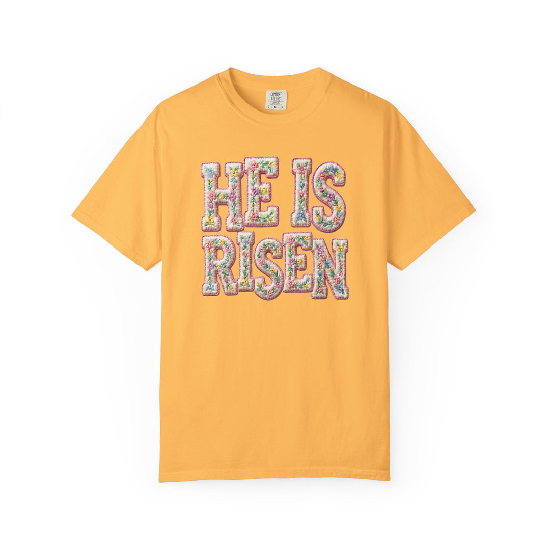 Mustard-yellow He is Risen tee with floral design, short-sleeve, cotton, from Comfort Colors, available in various sizes at Faith Family Designs.