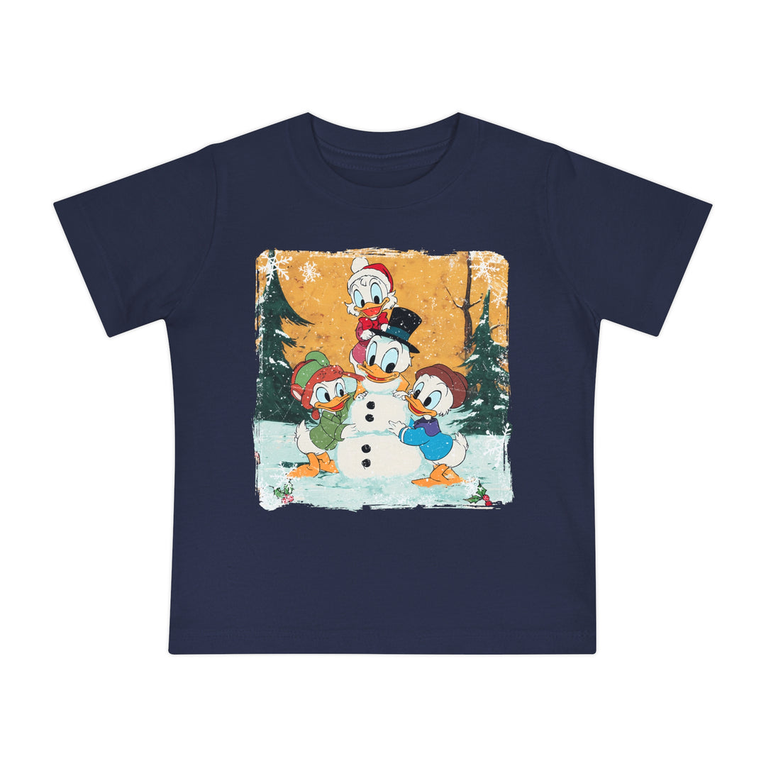 Navy-blue Duck Snowmen Baby Tee featuring Donald Duck and nephews building a snowman in a winter scene. Soft, durable, pre-shrunk cotton for babies' comfort.
