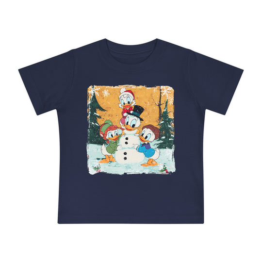 Navy-blue Duck Snowmen Baby Tee featuring Donald Duck and nephews building a snowman in a winter scene. Soft, durable, pre-shrunk cotton for babies' comfort.