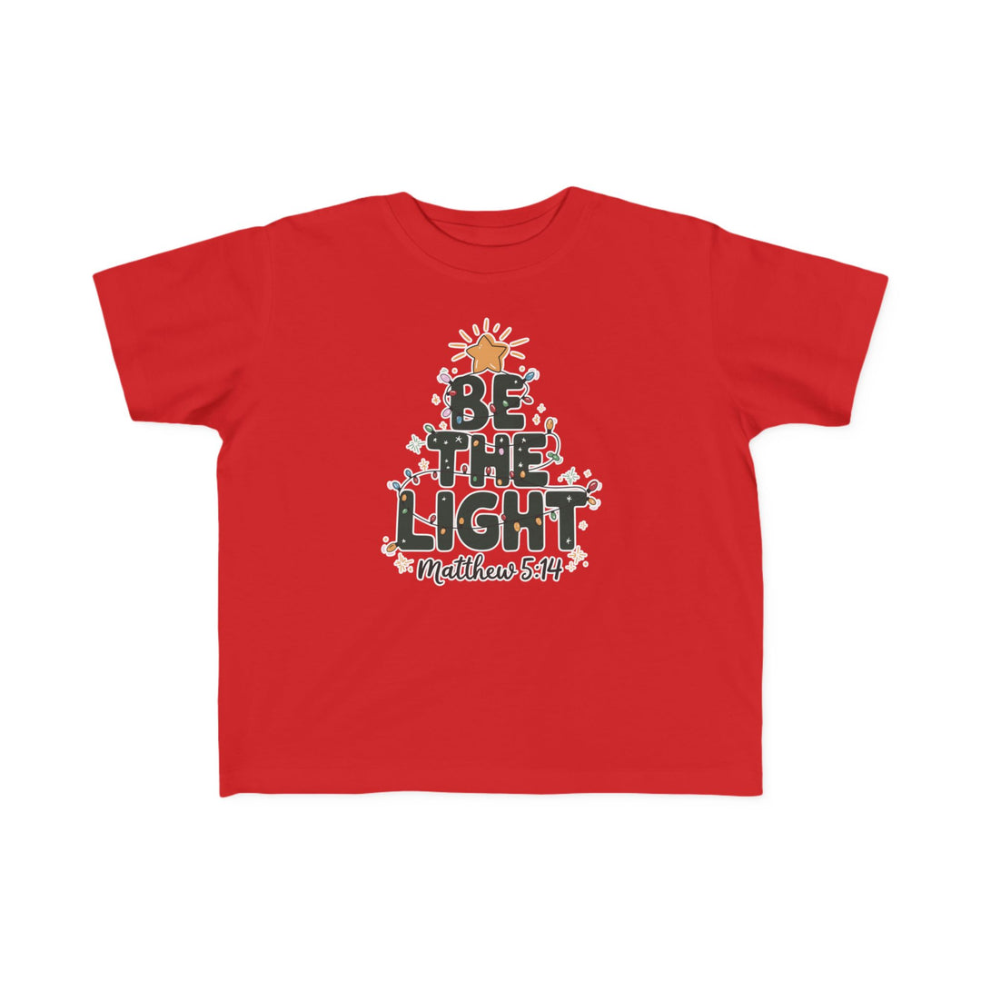 Be the Light Toddler Tee featuring a Christmas tree graphic with BE THE LIGHT and Matthew 5:14, perfect for toddlers with soft cotton and festive design.