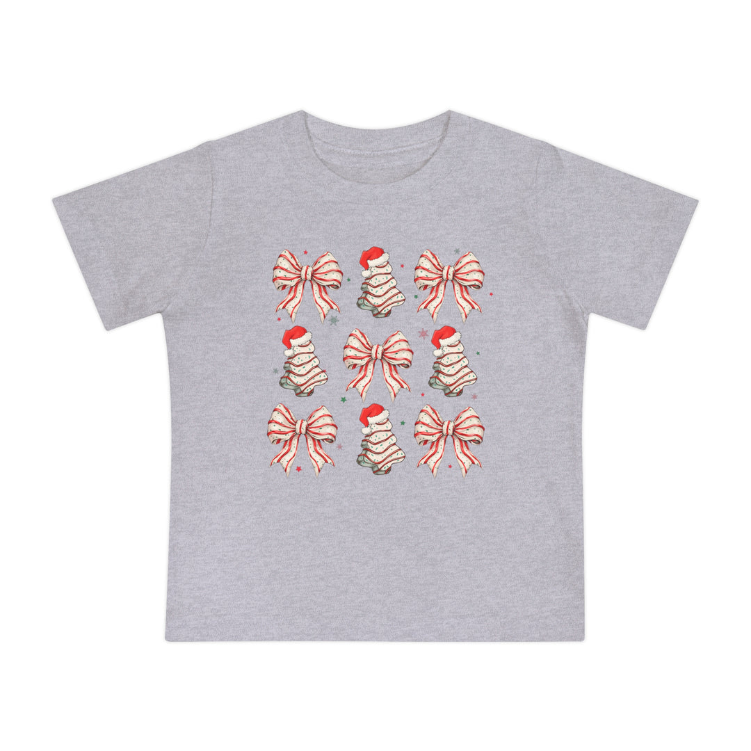 Cookies and Bows Baby Tee: Heather-gray T-shirt for infants, featuring a grid of festive red-and-white bows and Santa-topped tree motifs, perfect for holiday style.