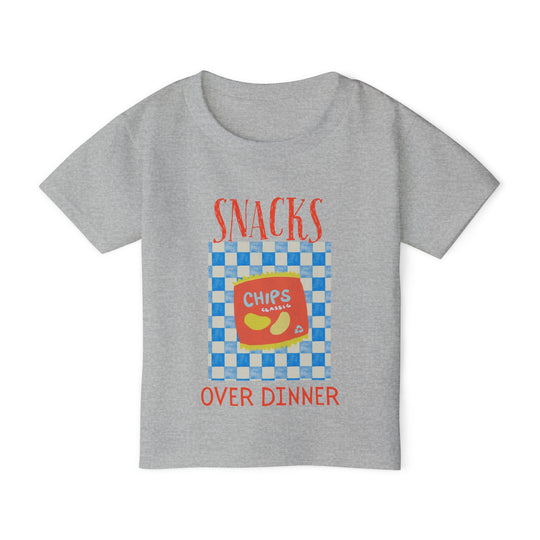 Heavy Cotton™ Toddler T-shirt featuring Snacks Over Dinner graphic with a chips illustration, blending playful style with eco-friendly, soft-touch cotton fabric.
