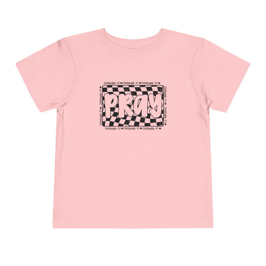 Pray Toddler Tee: Pink t-shirt featuring bold black and white text, made from soft Airlume cotton for toddlers' comfort. Ideal for playful, everyday wear.