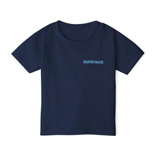 Heavy Cotton™ Toddler T-shirt in navy with HEAVEN MADE light-blue chest print, offering softness and comfort with eco-friendly cotton from Faith Family Designs.