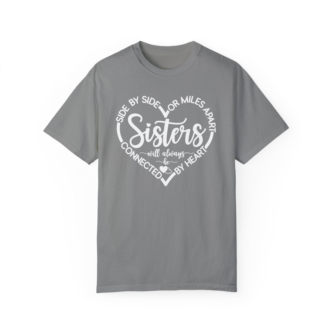 Sisters At Heart Tee: A grey t-shirt with white text, featuring a relaxed fit and durable, soft-washed, garment-dyed fabric for everyday comfort.
