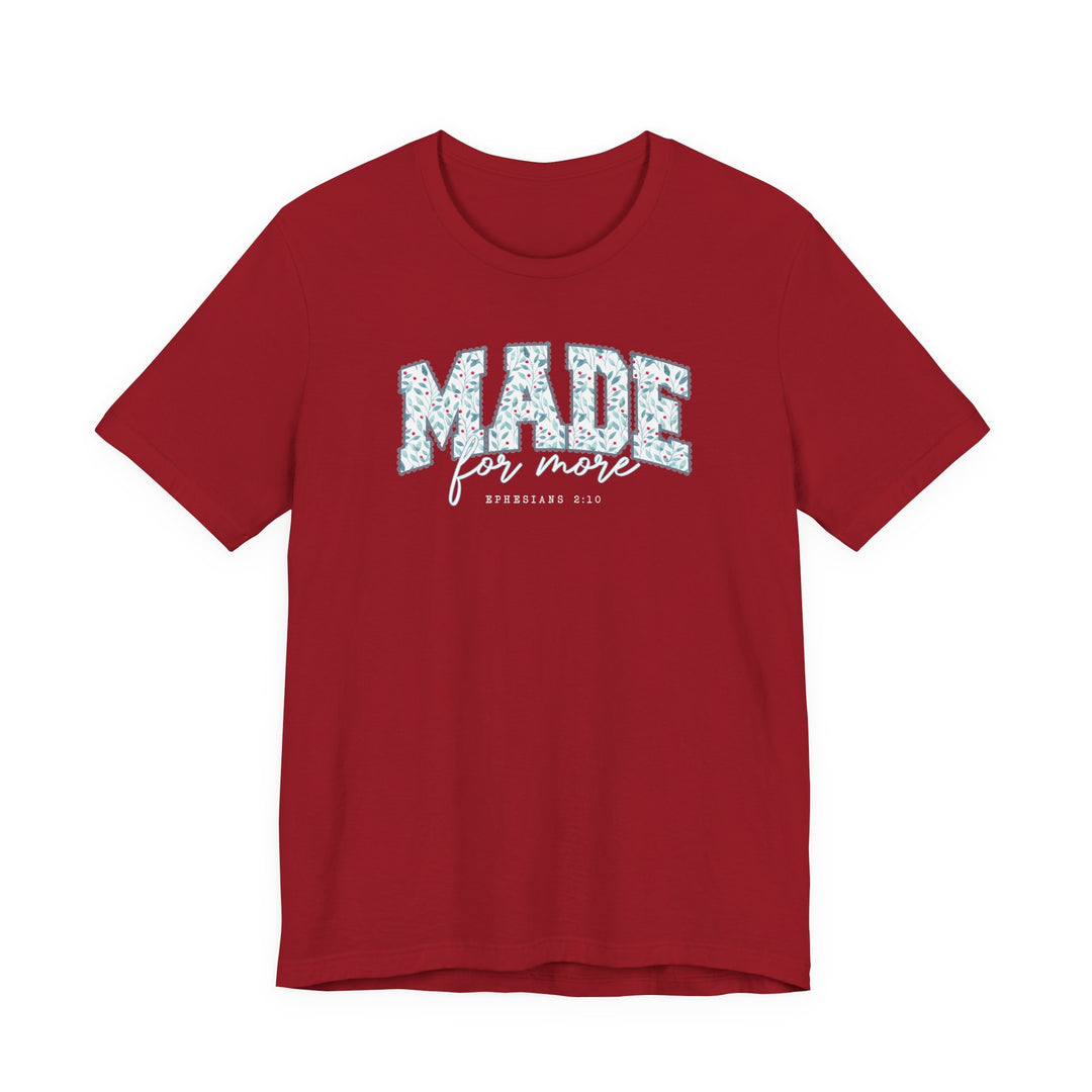 Red crew-neck T-shirt featuring MADE in blue leafy block letters, for more script, and Ephesians 2:10, highlighting Faith Family Designs' unique graphic tees.