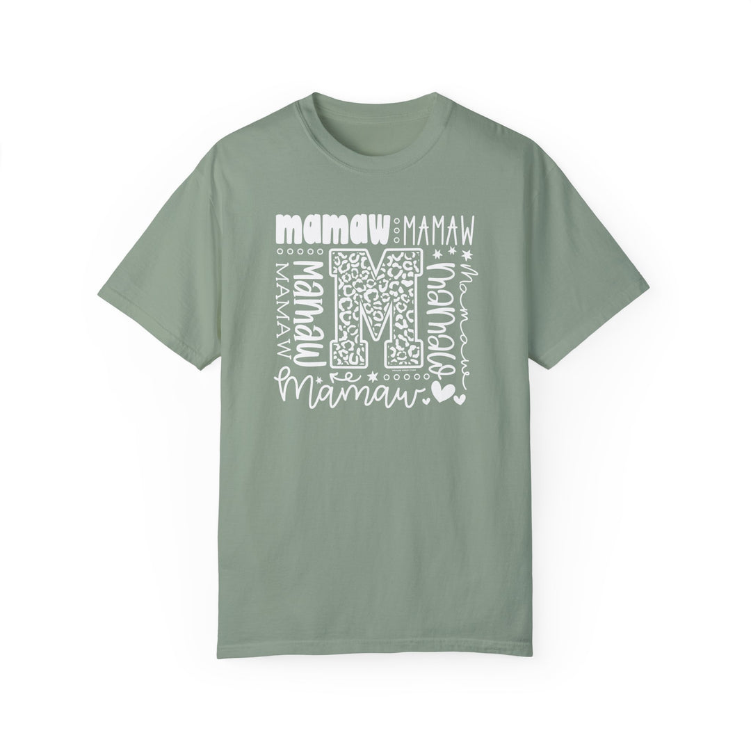 Comfort Colors 1717 Mamaw Tee: Green t-shirt with white 'M' logo, ring-spun cotton, relaxed fit, crew neckline, durable double-needle stitching, no side-seams. Available in various sizes. Ethically made in the US.