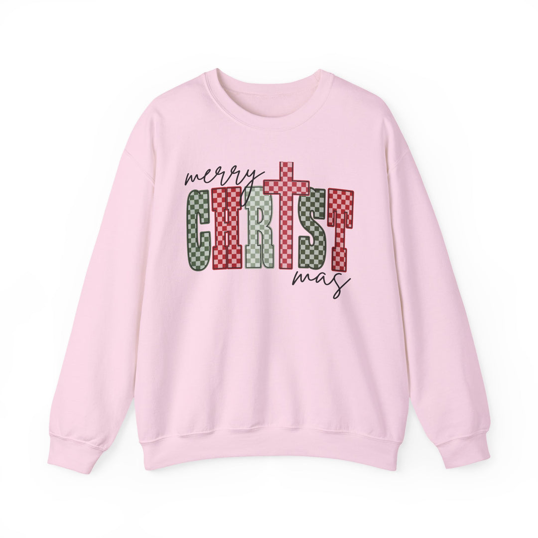 Light-pink Christmas Crew sweatshirt with Merry Christmas in script and checkerboard block letters, showcasing festive design. Perfect for cozy winter wear.