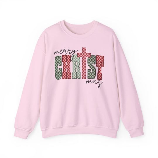 Light-pink Christmas Crew sweatshirt with Merry Christmas in script and checkerboard block letters, showcasing festive design. Perfect for cozy winter wear.