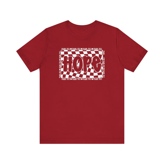 Hope Tee: A classic unisex red t-shirt featuring a white and red checkered design, crafted from soft cotton for a comfortable fit and durable wear.