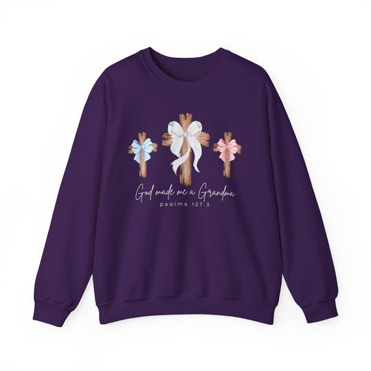 Purple crewneck sweatshirt with 'God Made Me a Grandma' graphic featuring three wooden crosses with bows, ideal for comfort with a polyester-cotton blend.