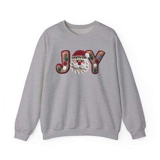 Light-heather gray crewneck sweatshirt with JOY appliqué, featuring multicolored knit letters and a Santa-face motif, offering a relaxed, unisex fit.