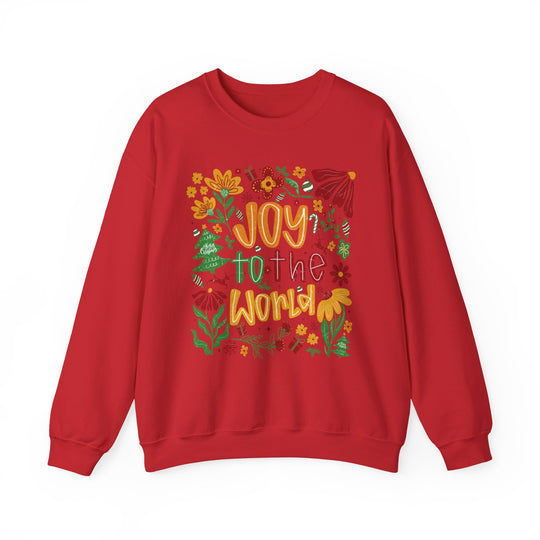 Red crew-neck sweatshirt with Joy to the World in stylized lettering, surrounded by festive holiday illustrations like holly, candy canes, and ornaments. Cozy, durable, unisex design.