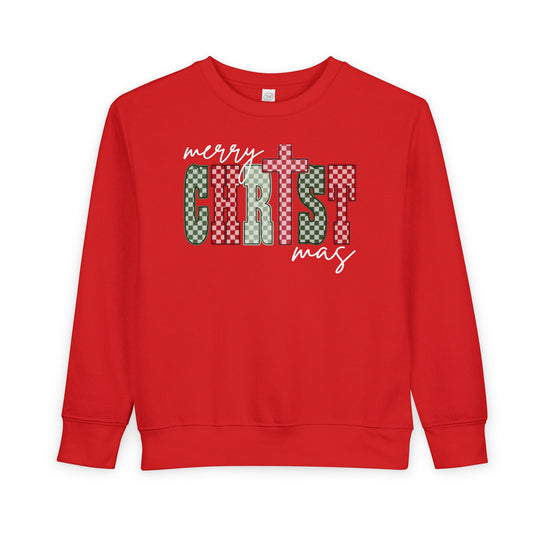 Christmas Toddler Crew: Red crew-neck sweatshirt with merry CHRIST mas in festive checkerboard pattern, designed for warmth and comfort in a cotton-polyester blend.