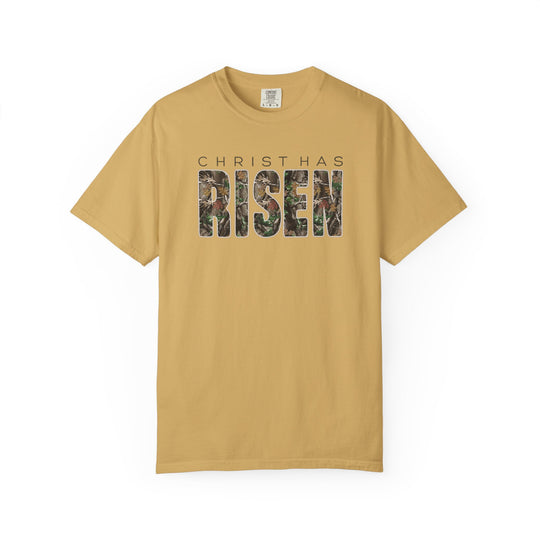 Mustard-colored Christ Has Risen T-shirt with camouflage-patterned RISEN text, offering a relaxed fit and crafted from a soft cotton-polyester blend.