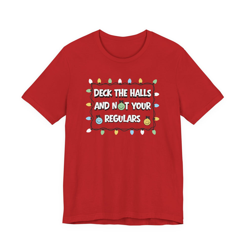 Red Regulars Tee with Christmas lights frame and humorous text, featuring smiling ornaments. Classic unisex fit with soft cotton and ribbed knit collars.