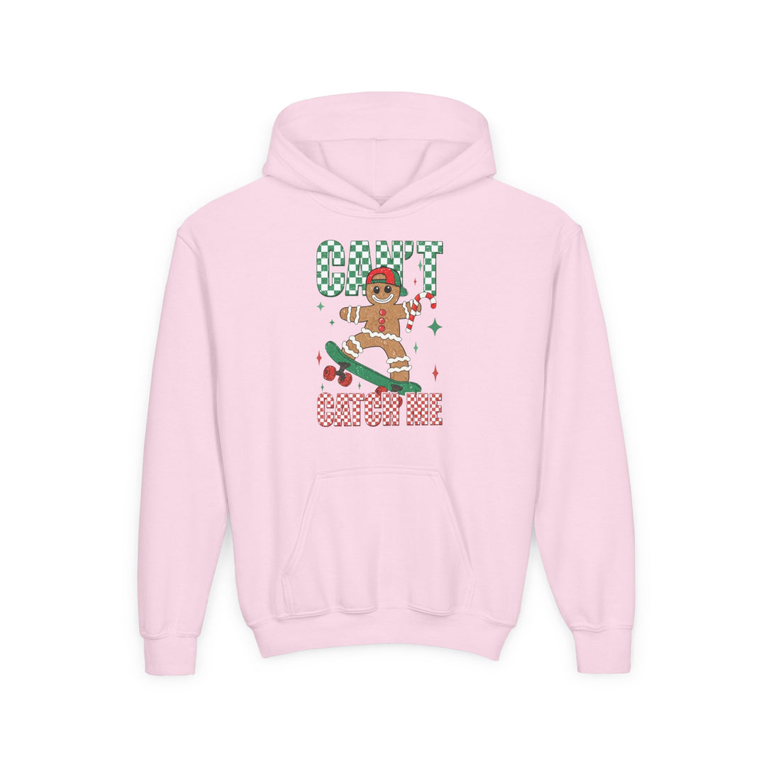 Can't Catch Me Youth Hoodie features a gingerbread man on a skateboard with a candy cane, surrounded by festive text and sparkles, perfect for holiday fun.