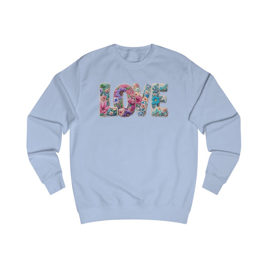 Light blue crewneck sweatshirt with LOVE in floral design on chest, showcasing unique style and comfort from Faith Family Designs.