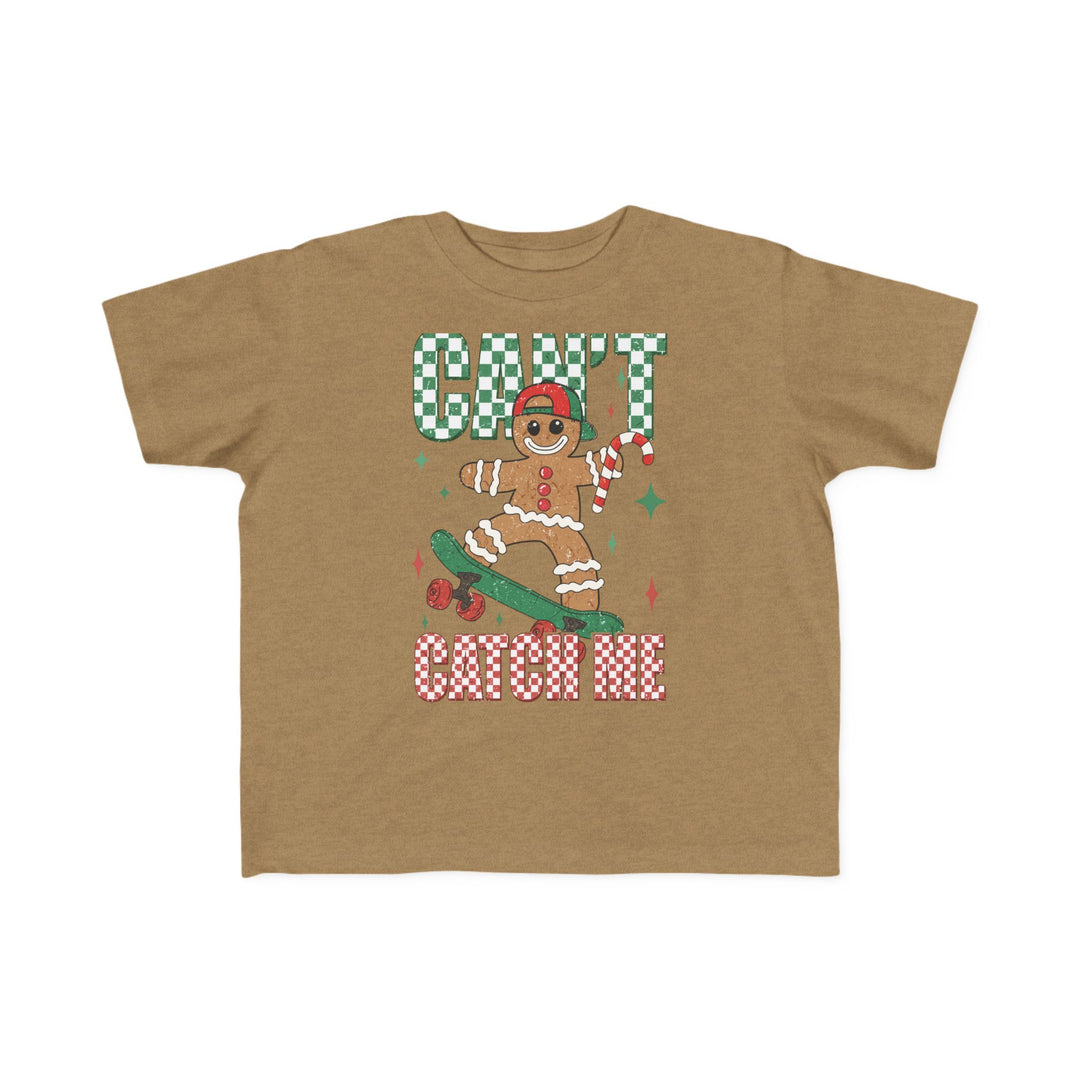 Can't Catch Me Toddler Tee featuring a gingerbread skateboarder with a candy cane, checkerboard text, and soft, durable fabric ideal for toddlers.