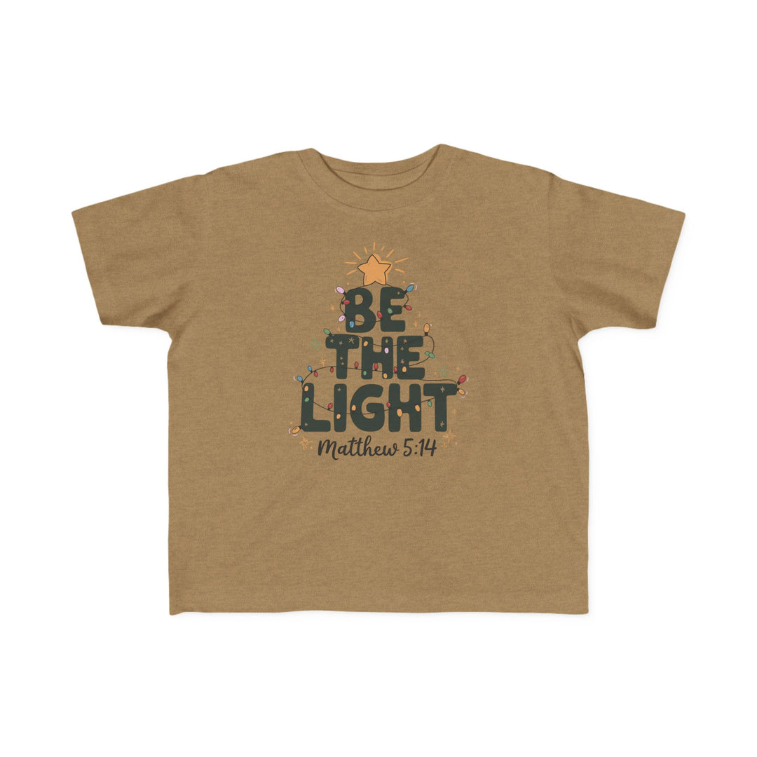 Be the Light Toddler Tee featuring a holiday-themed graphic with BE THE LIGHT, colored lights, a star, and Matthew 5:14, perfect for sensitive toddler skin.