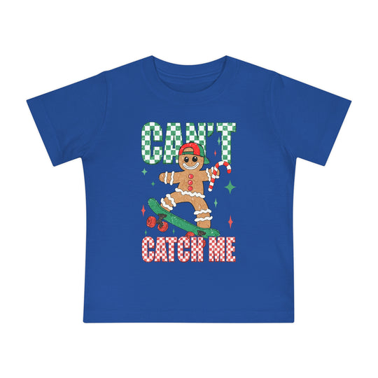 Can't Catch Me Baby Tee: A royal-blue kids’ T-shirt featuring a gingerbread man on a skateboard with festive sparkles, designed for comfort and durability.