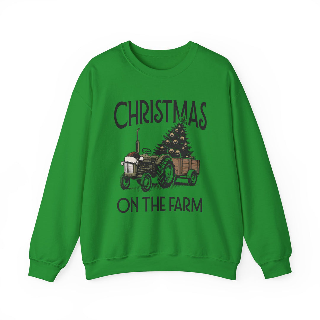 Green crewneck sweatshirt featuring a rustic holiday graphic with a tractor towing a decorated Christmas tree, labeled CHRISTMAS ON THE FARM. Cozy, durable cotton-polyester blend.