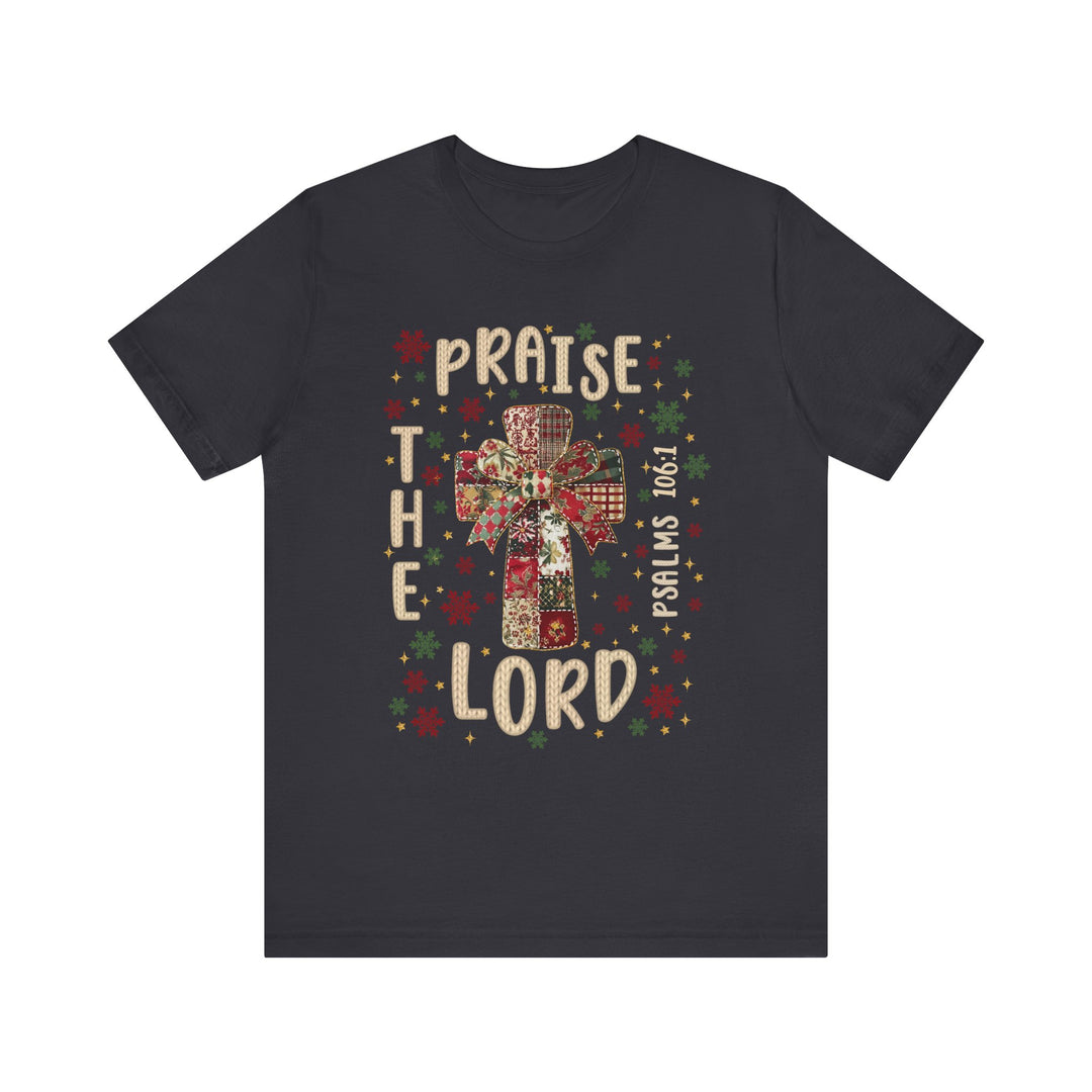 Praise the Lord Tee featuring a quilt-patterned cross with festive motifs and Psalm 106:1, perfect for a comfortable, stylish expression of faith.