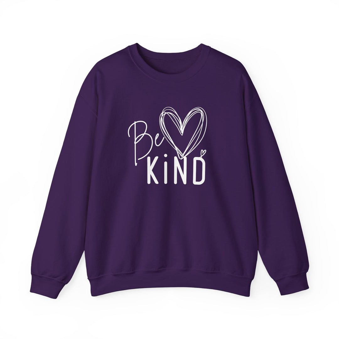 Deep purple crewneck sweatshirt with Be KIND in white, featuring a heart-shaped K, highlighting the garment's relaxed fit and ribbed cuffs.