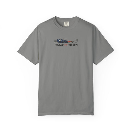 Hooked on Freedom Tee: Gray Comfort Colors t-shirt featuring a stars-and-stripes fishing lure graphic with HOOKED on FREEDOM slogan beneath. Relaxed fit, durable, 100% cotton.