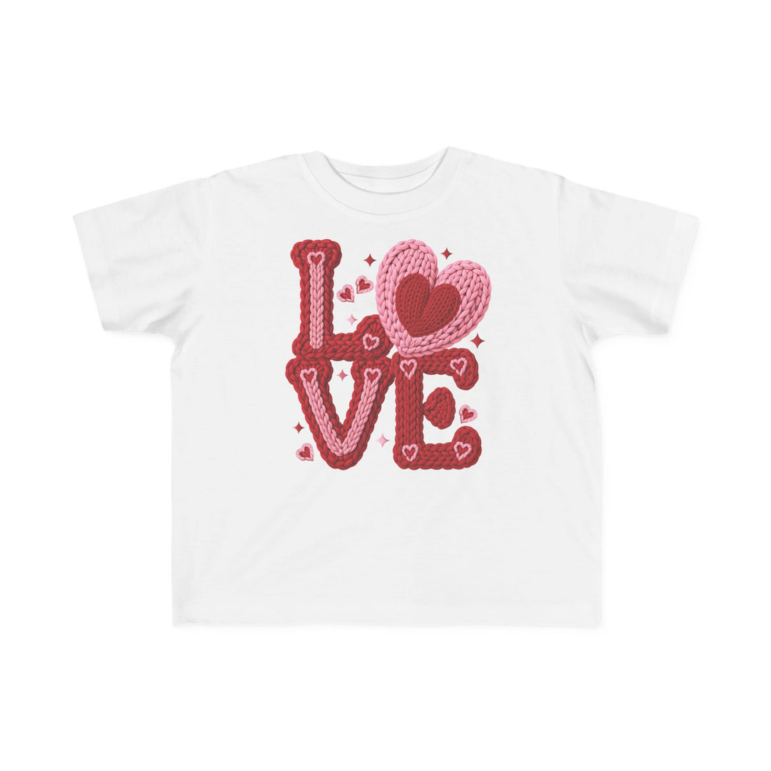 Love Heart Toddler Tee features a white T-shirt with LOVE in red and pink, yarn-knit style, accented by hearts and sparkles, ideal for toddlers' soft skin.