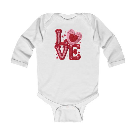 White long-sleeved baby onesie with LOVE in red and pink knit lettering, heart-shaped O, designed for comfort and durability.
