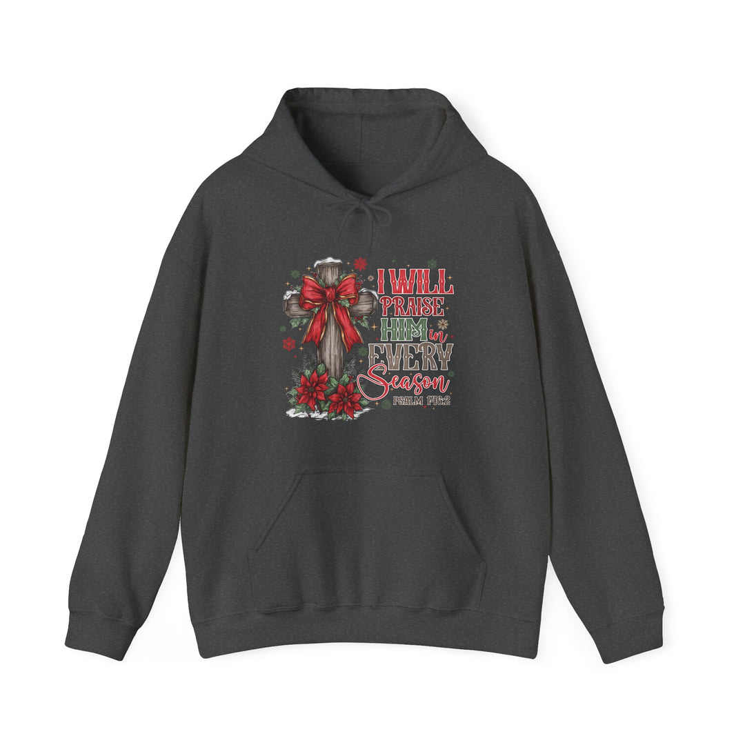 Praise Him in Every Season Hoodie featuring a rustic cross with a red bow, poinsettias, holly, snowflakes, and Psalm 146:2. Cozy, unisex, perfect for winter.
