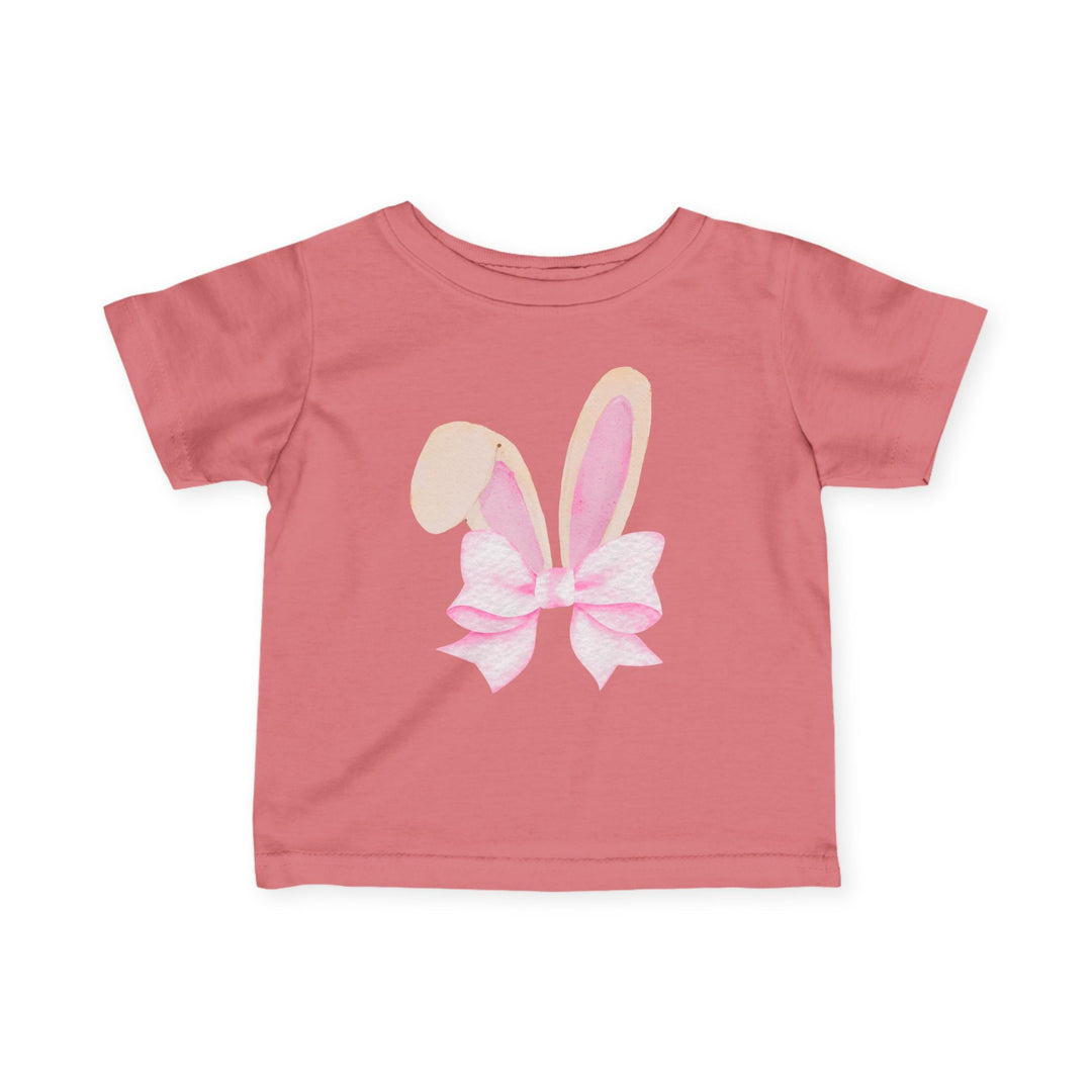 Bunny Bow Baby Tee in muted pink features a watercolor graphic of bunny ears with a bow, designed for comfort and durability with 100% cotton and taped shoulders.