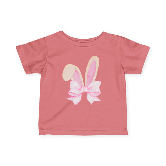 Bunny Bow Baby Tee in muted pink features a watercolor graphic of bunny ears with a bow, designed for comfort and durability with 100% cotton and taped shoulders.