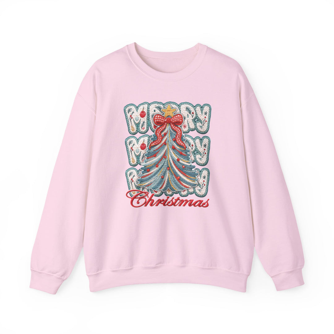 Light-pink crewneck sweatshirt featuring a stylized Christmas tree with a red bow and ornaments, and Merry Christmas text. Cozy, unisex design for colder months.