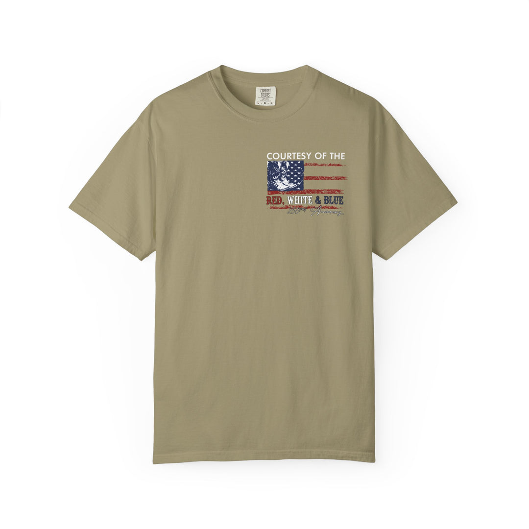 Crew neck khaki Comfort Colors tee with a distressed American flag and 'Courtesy of the Red, White & Blue' graphic, celebrating 250th anniversary, short sleeves.