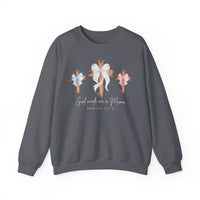 Dark-gray sweatshirt with three wooden crosses, bows, and 'God Made Me a Mama' script, offering comfort and style from Faith Family Designs.