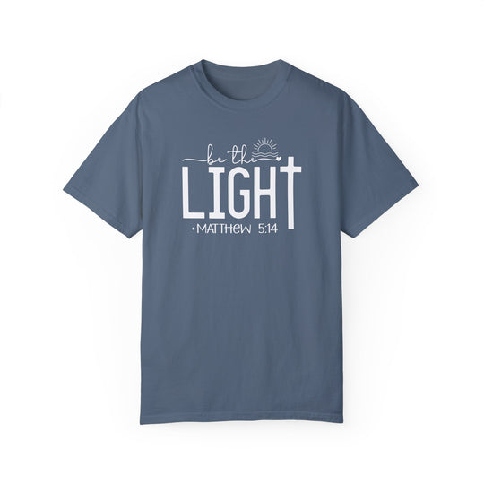 A ring-spun cotton Be the Light Tee, garment-dyed for extra coziness. Relaxed fit, double-needle stitching for durability, and seamless design for a tubular shape. From Worlds Worst Tees.