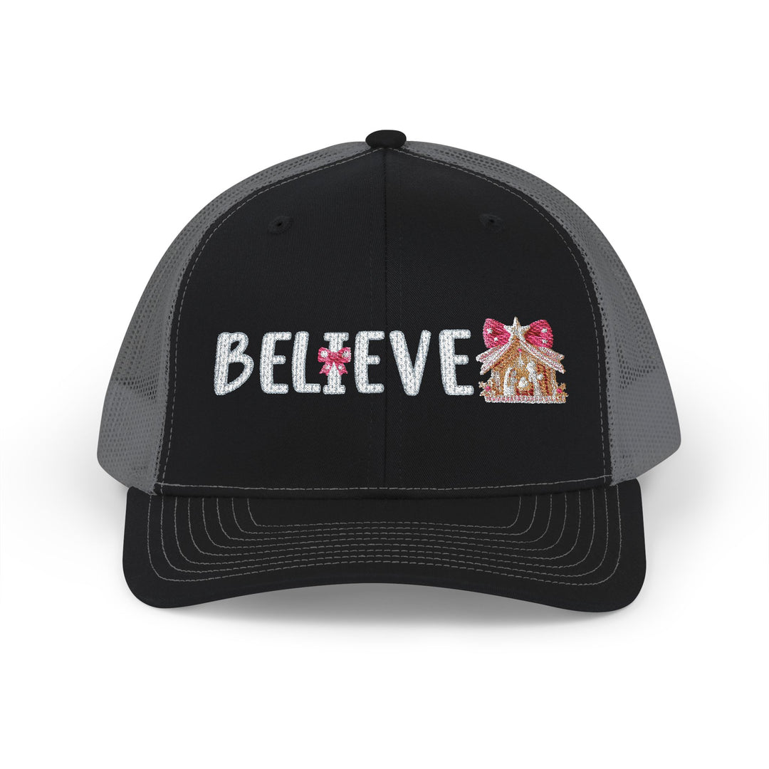 Believe Snapback Trucker Cap features a glittery 'BELIEVE' text with candy-cane ornament and gingerbread house, offering a stylish, breathable design with adjustable fit.