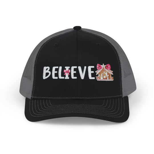Believe Snapback Trucker Cap features a glittery 'BELIEVE' text with candy-cane ornament and gingerbread house, offering a stylish, breathable design with adjustable fit.