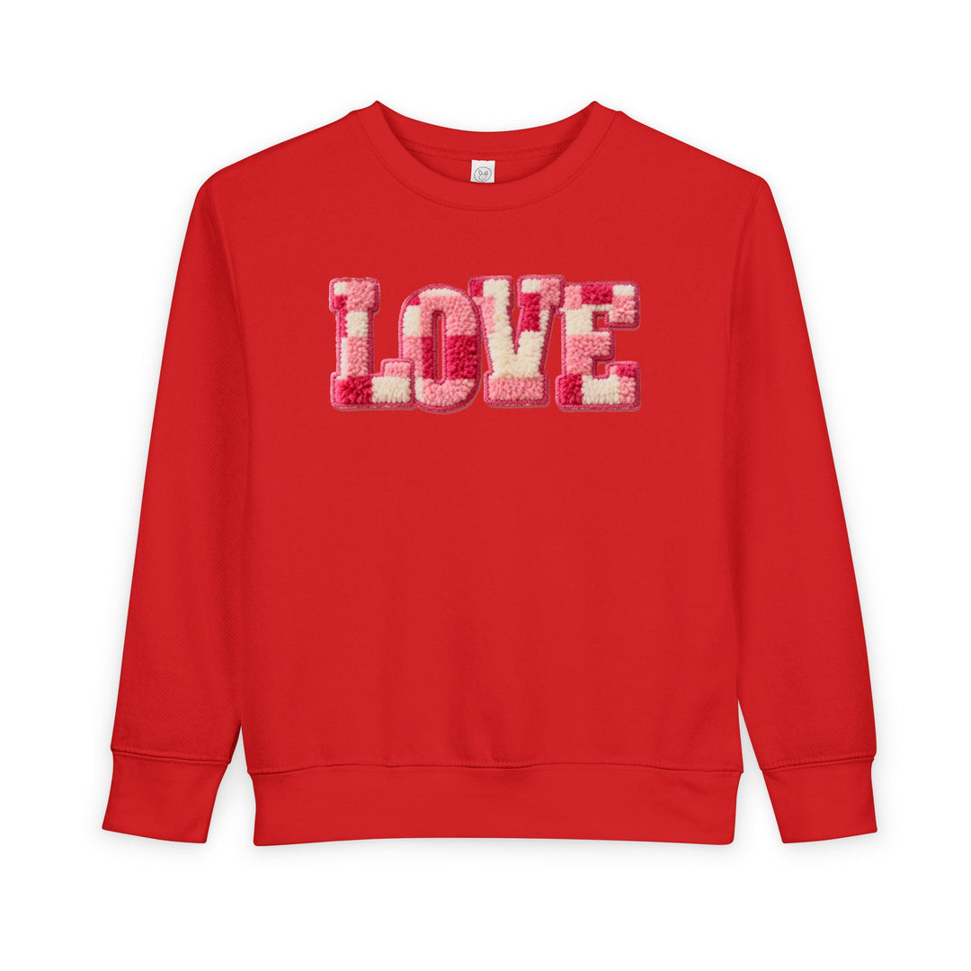 Bright red toddler crewneck sweatshirt with LOVE in fuzzy pink, cream, and red letters, offering cozy warmth and durability for stylish comfort.