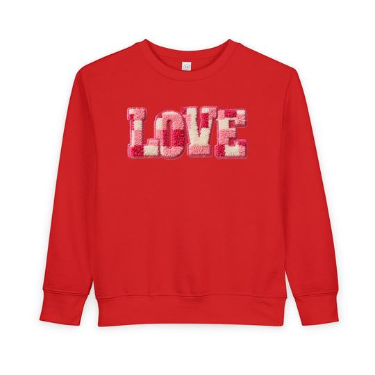 Bright red toddler crewneck sweatshirt with LOVE in fuzzy pink, cream, and red letters, offering cozy warmth and durability for stylish comfort.
