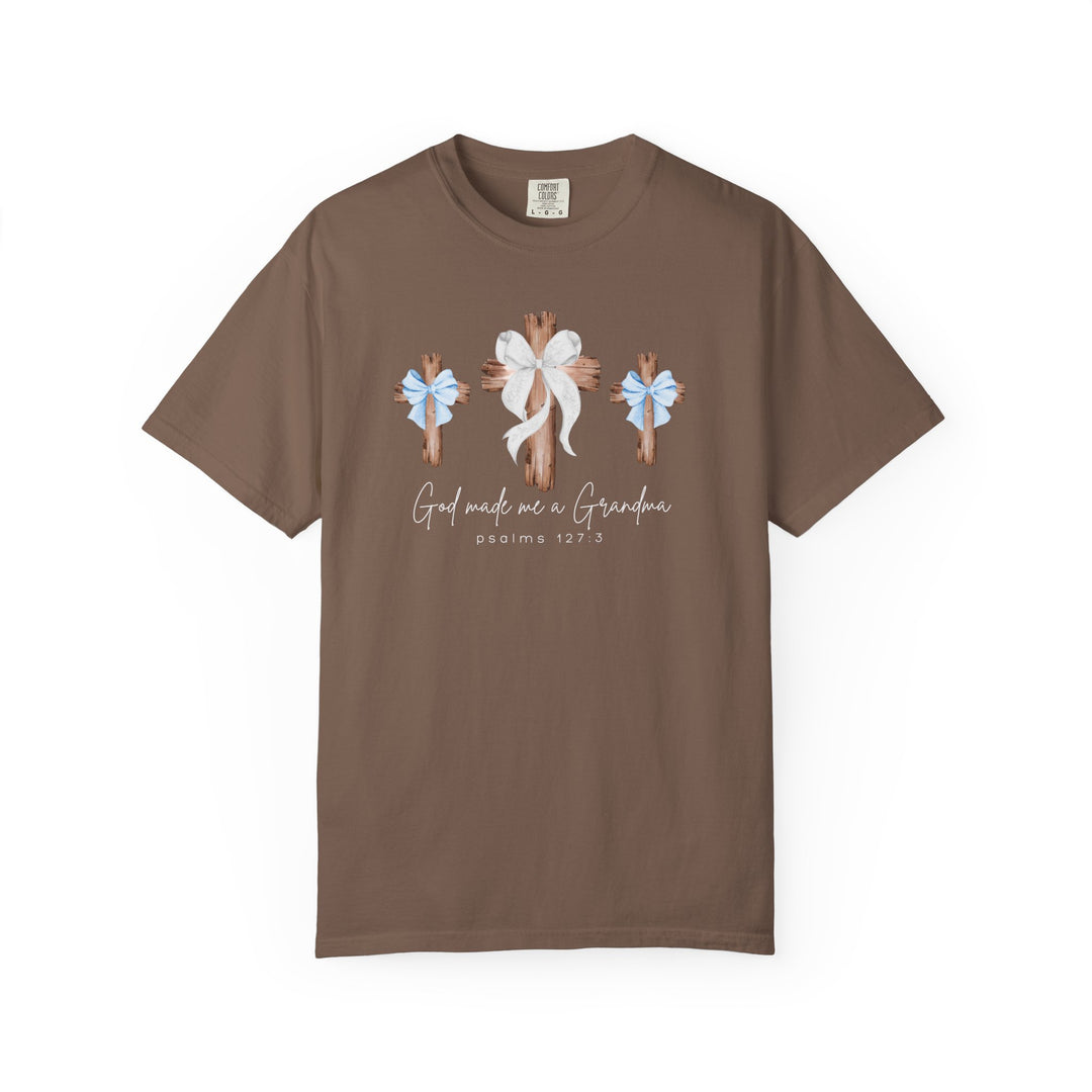Brown crew-neck tee with three rustic crosses and bows, featuring the phrase “God made me a Grandma” and “Psalms 127:3.” Made from soft, durable cotton.