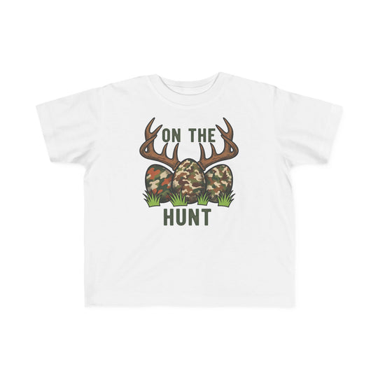 On the Hunt Toddler Tee featuring camouflage eggs with antlers graphic, ideal for sensitive skin, made from soft cotton, perfect for toddlers' adventures.